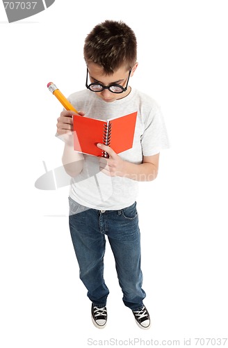 Image of Boy writing in notebook