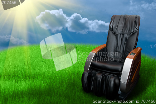 Image of massage arm-chair on the grass field