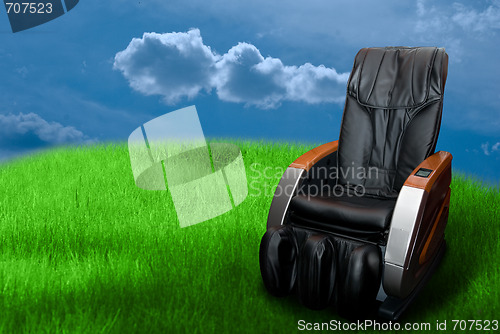 Image of massage arm-chair on the green grass