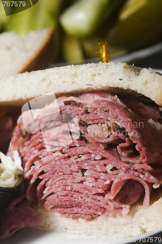 Image of corned beef pastrami combination sandwich rye bread pickles