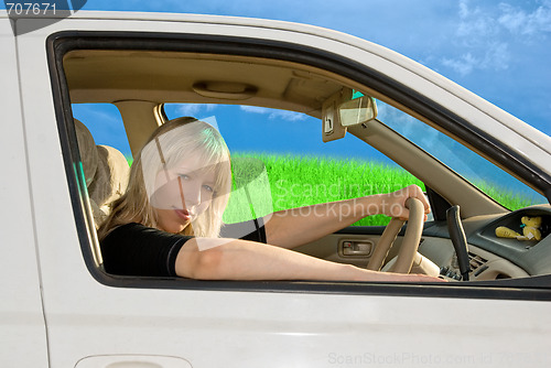 Image of young woman driving