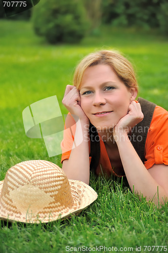 Image of Young woman laying on the grass