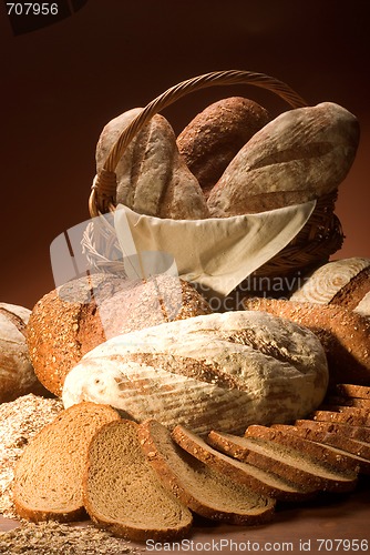 Image of assortment of baked bread over brown background