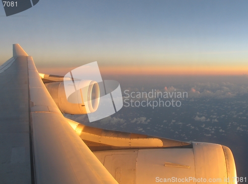 Image of Airplane wing under sunset