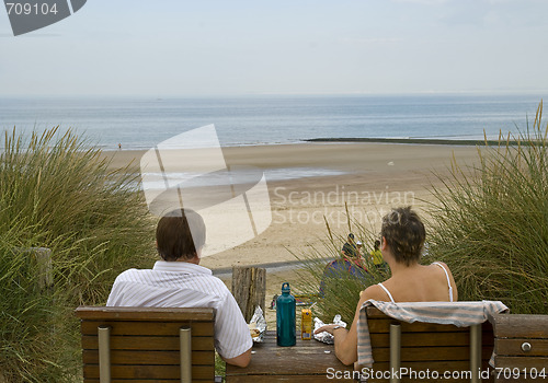 Image of Couple relaxing at the beach