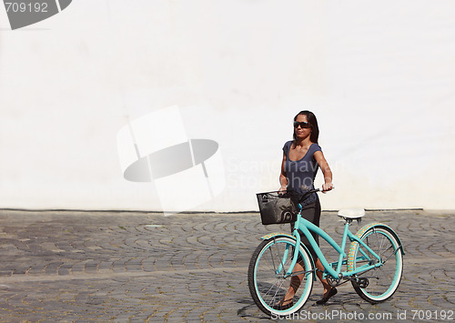 Image of Woman With A Bicycle In A City