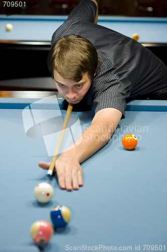 Image of caucasian man playing pool