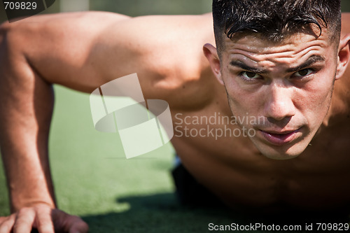 Image of Hispanic athlete push-up