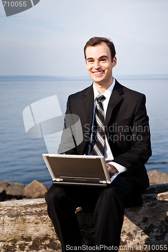 Image of Caucasian businessman with laptop