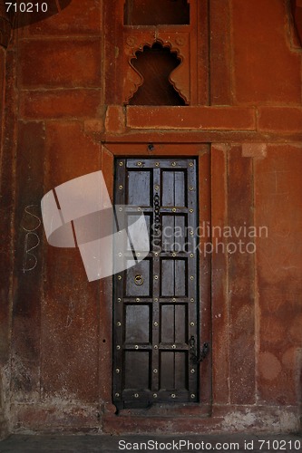 Image of Beautiful wooden door with golden flowers on it. Fatehpur Sikri,