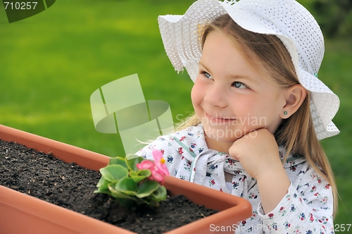 Image of Little girl  - gardening
