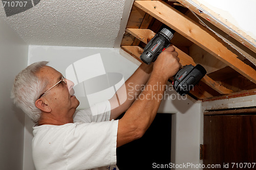 Image of Senior man fixing stairs