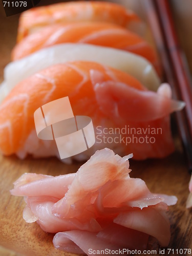 Image of Sushi - Japonese food (on a wooden plate)