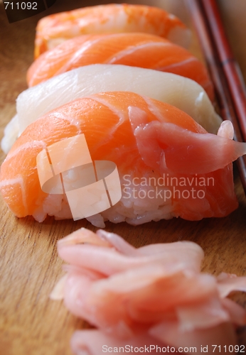 Image of Sushi - Japonese food (on a wooden plate)