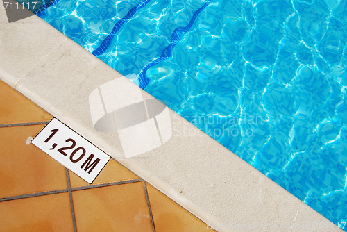 Image of Pool depth sign at the edge of the swimming pool