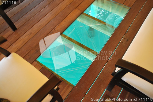 Image of Bungalow interior with a floor detail to blue ocean