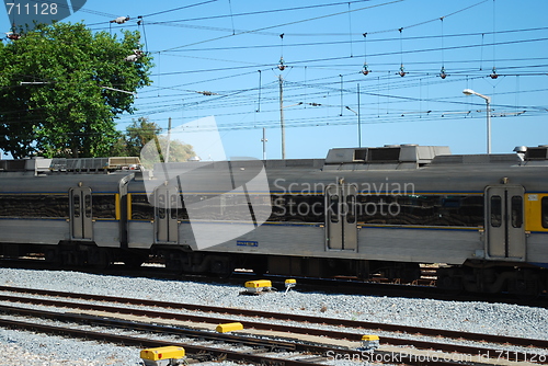 Image of Gray train passing a local village