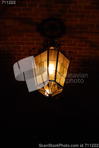 Image of Ancient lantern on a brick wall