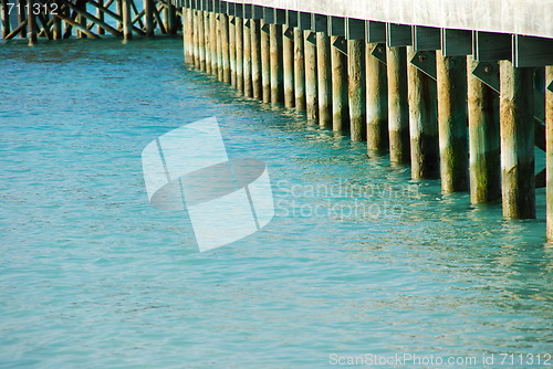 Image of Wooden jetty bridge on a beautiful Maldivian beach