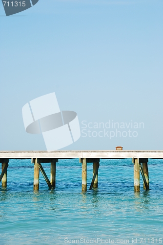 Image of Wooden jetty bridge on a beautiful Maldivian beach