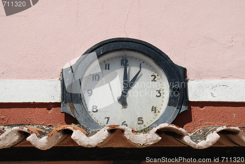 Image of Ancient clock above roof tiles (1 o'clock)