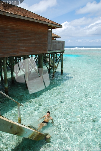 Image of Young man relaxing in Maldives