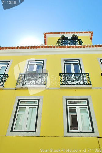 Image of Bright sun with a traditional house building in Lisbon