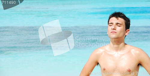 Image of Man standing up sunbathing in a Maldivian Island