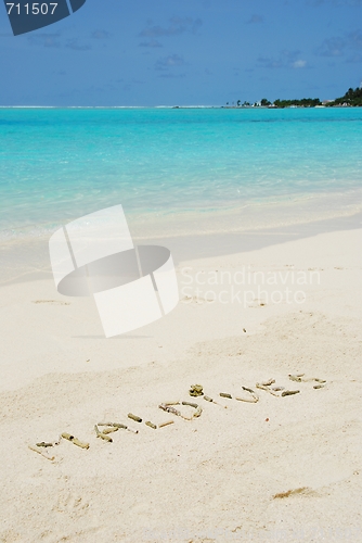 Image of Maldives written in a sandy tropical beach