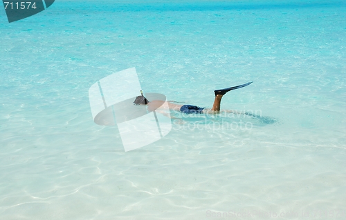 Image of Young man snorkeling in Maldives (blue ocean water)