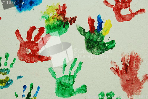 Image of Wall painted with colorful kids hand prints