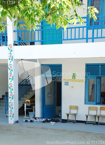 Image of Blue Maldivian school with trainers outside