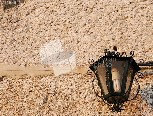 Image of Old lantern with granite wall background