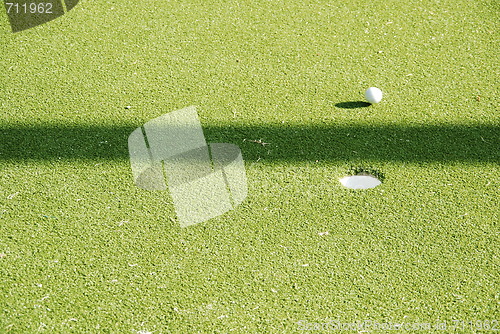 Image of Golf green and ball on movement
