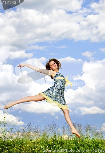 Image of Young girl jumping in meadow