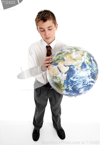 Image of Boy holding blow up ball of the Earth world