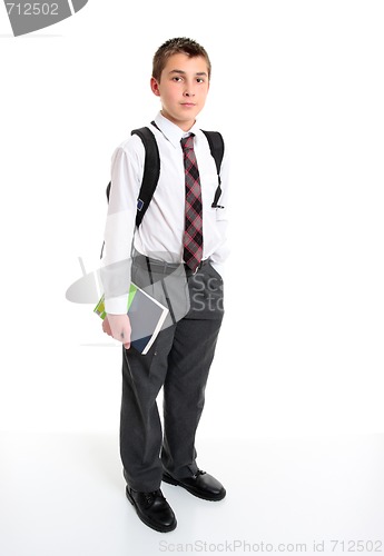 Image of School student in white shirt and greay trousers.