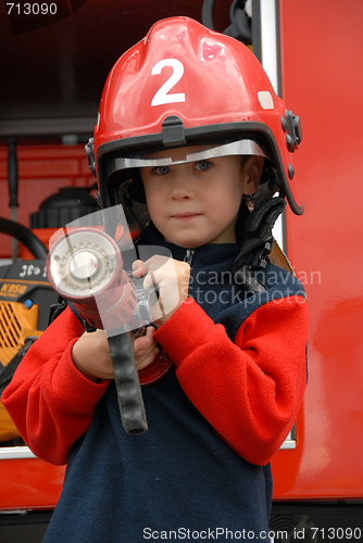 Image of boy is sitting in a fire truck