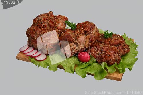 Image of Smoked chicken kebab on wooden board.