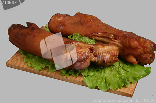 Image of Smoked trotters on wooden board.