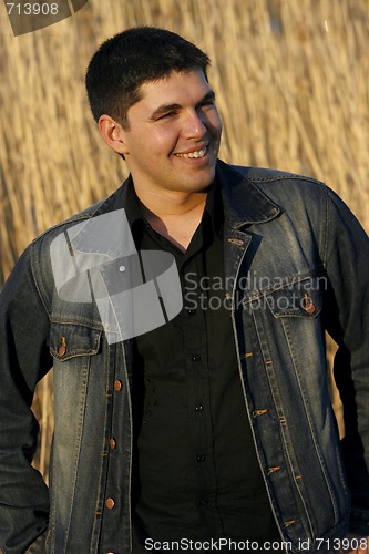 Image of Young handsome man laughing
