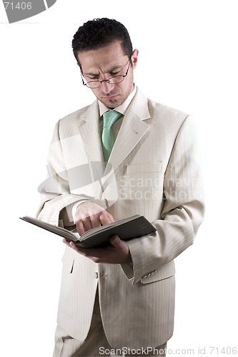 Image of Businessman with a pair of glassed reading a book