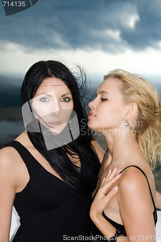 Image of Portrait of the two young women against the cloudy sky