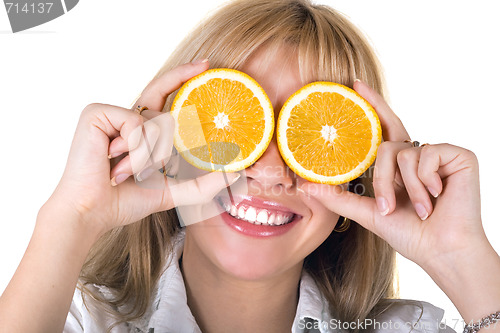 Image of Portrait of the funny smiling girl with oranges. Isolated