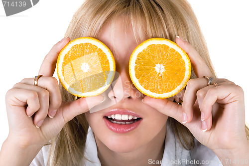 Image of Portrait of the funny young woman with oranges. Isolated