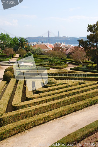 Image of Enchanted Ajuda garden with April 25th bridge in Lisbon, Portugal