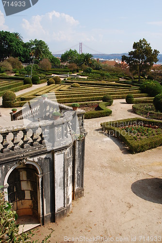 Image of Enchanted Ajuda garden with April 25th bridge in Lisbon, Portugal