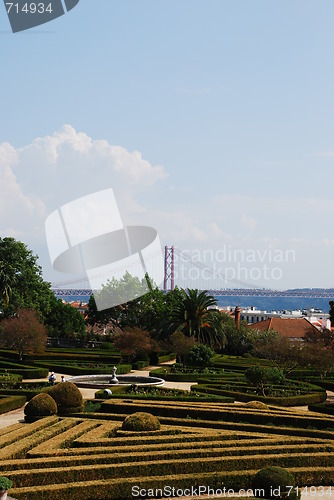 Image of Enchanted Ajuda garden with April 25th bridge in Lisbon, Portugal