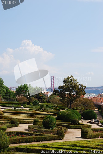 Image of Enchanted Ajuda garden with April 25th bridge in Lisbon, Portugal