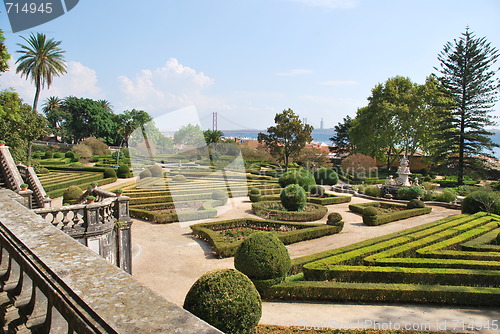 Image of Enchanted Ajuda garden with April 25th bridge in Lisbon, Portugal